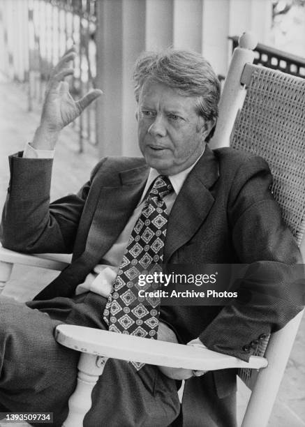 American politician Jimmy Carter, Governor of Georgia, sitting in a rocking chair at his home in Plains, Georgia, 1974. Carter served two terms as a...