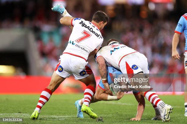 Angus Crichton of the Roosters is tackled by Ben Hunt and Josh McGuire during the round seven NRL match between the St George Illawarra Dragons and...