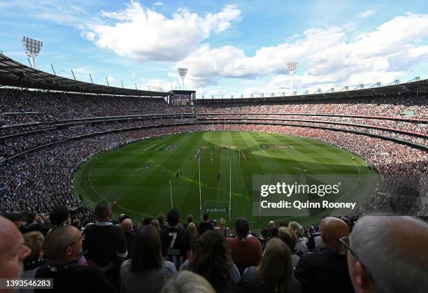 The crowd stands for a minute silence for Anzac Day during the round six AFL match between the Essendon Bombers and the Collingwood Magpies at...