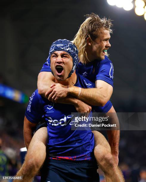 Jahrome Hughes of the Storm celebrates scoring a try with Ryan Papenhuyzen of the Storm during the round seven NRL match between the Melbourne Storm...