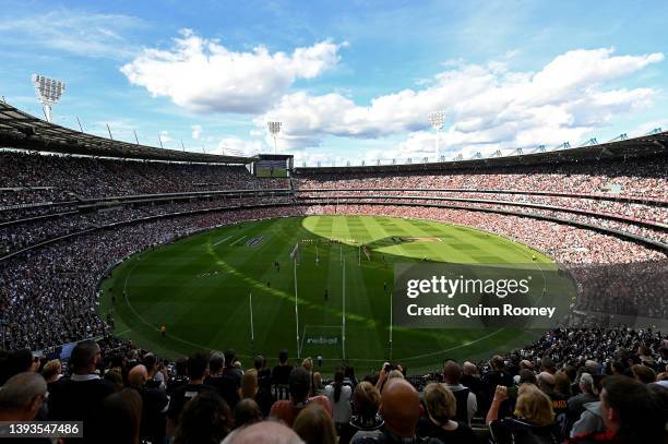 The crowd stands for a minute silence for Anzac Day during the round six AFL match between the Essendon Bombers and the Collingwood Magpies at...