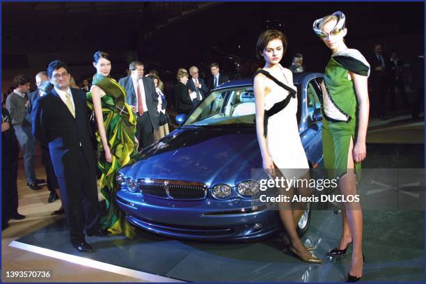 At the Louvre Pyramid, Vittorio Senso, general director of Jaguar France, and left to right: dresses specially made for the X Type by 3 young...