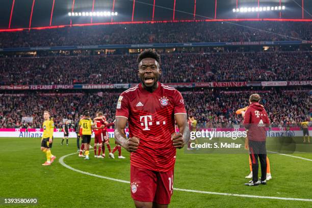 Alphonso Davies of FC Bayern Muenchen celebrating the win of the 10th german championship in a row after the Bundesliga match between FC Bayern...