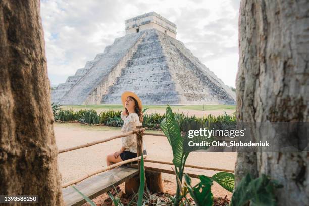 woman sitting with view on chichen itza pyramid in mexico - cancun beautiful stock pictures, royalty-free photos & images