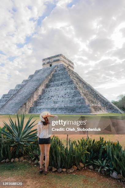 woman on the background of chichen itza pyramid in mexico - mayan pyramid stock pictures, royalty-free photos & images