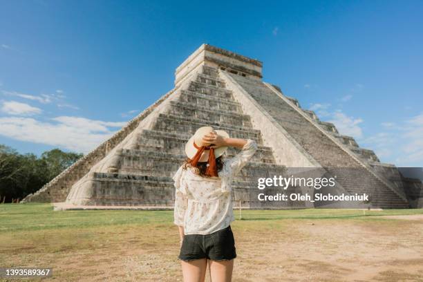 woman on the background of chichen itza pyramid in mexico - chichen itza stock pictures, royalty-free photos & images