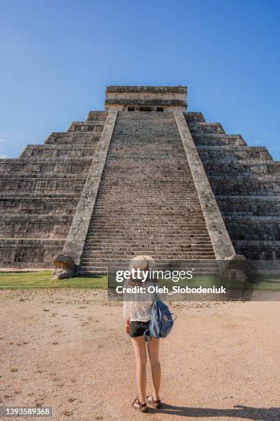 rear view of woman standing  on the background of chichen itza pyramid in mexico - mayan ruin stock pictures, royalty-free photos & images