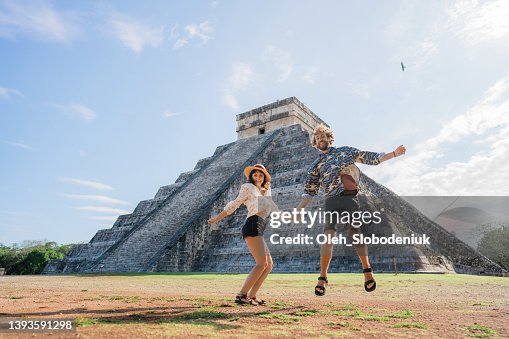 Couple on the background of Chichen Itza pyramid in Mexico Couple on the background of Chichen Itza pyramid in Mexico