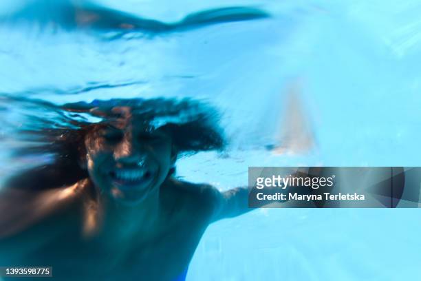 a dark-skinned girl dives into a pool underwater. active and fun pastime for the child. summer. summer vacation. vacation. - one teenage girl only bildbanksfoton och bilder
