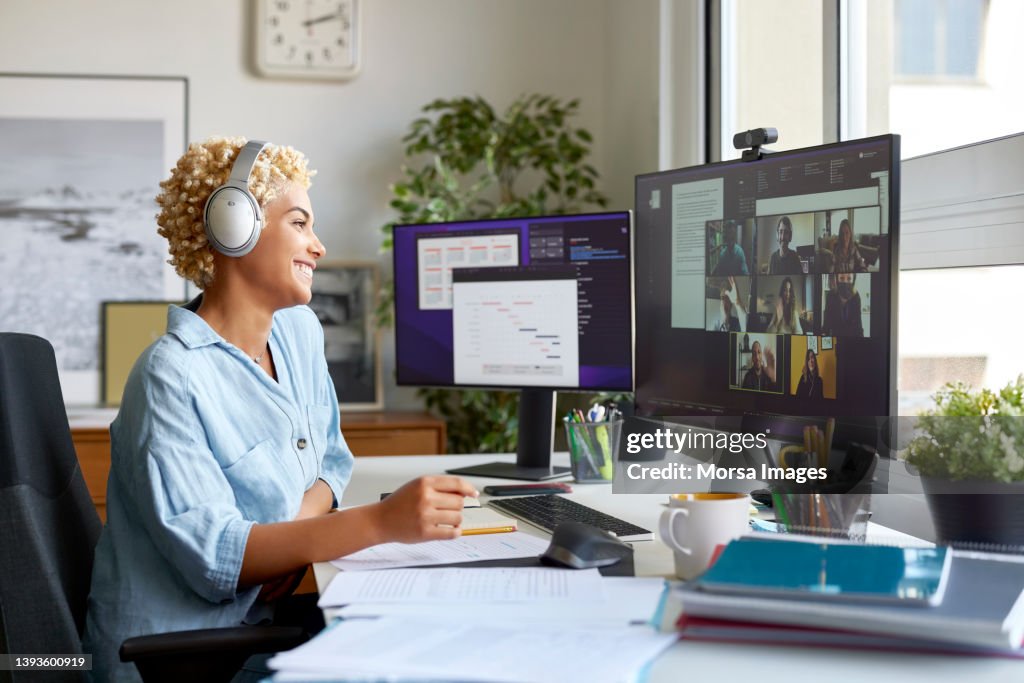 Happy Businesswoman on Video Call With Colleagues