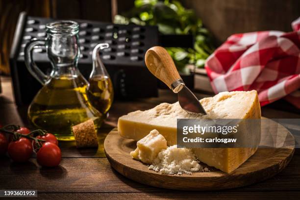 parmesan cheese on a wooden rustic table - parmesan imagens e fotografias de stock