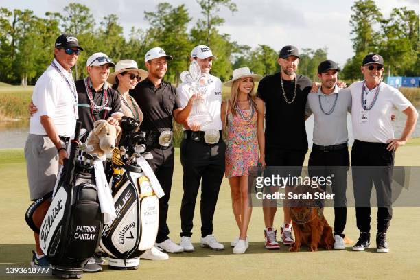 Patrick Cantlay pose with his partner Nikki Guidish and Xander Schauffele and his wife Maya and other friends and family after their team putted in...