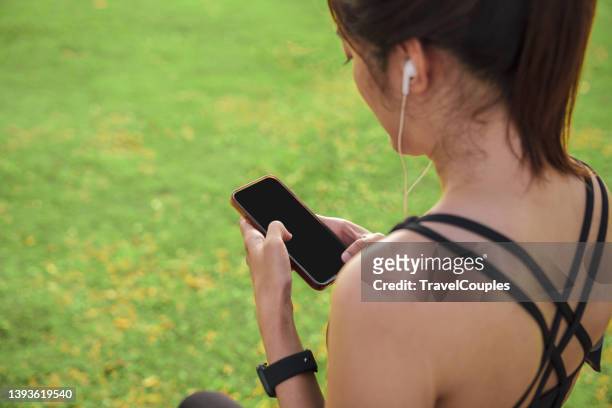 women setting up the fitness smart watch for running. young fitness women runner checking time from smart watch. young woman checking heart rate while jogging in the park. - running gear stock pictures, royalty-free photos & images