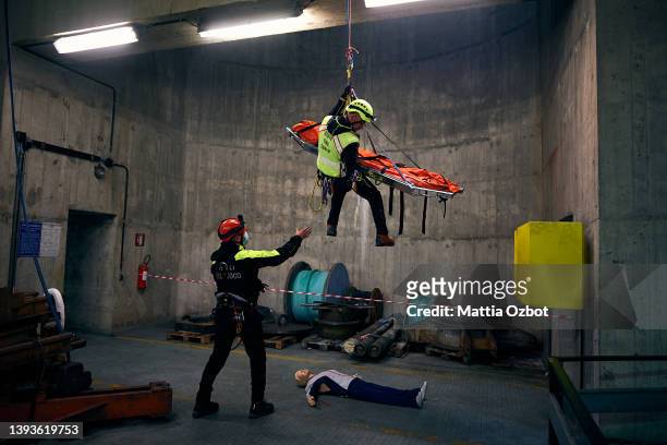 Rescuers in action during the maxi emergency drill of the firefighters and the Red Cross with real rescue simulations in the hydroelectric power...
