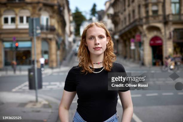 portrait of teenage girl with red hair in the city - woman waist up stock-fotos und bilder