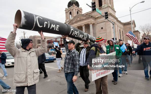 Protesters march in downtown Wichita, Kansas, as part of "Occupy Koch Town," Saturday, February 18, 2012. The rally and march were organized by the...
