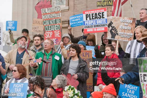 Protesters gather during a march in downtown Wichita, Kansas, as part of "Occupy Koch Town," Saturday, February 18, 2012. The rally and march were...