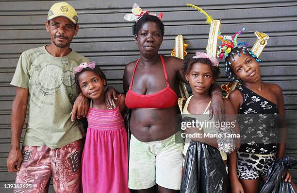 Members of the Juciara family pose while taking a break from gathering aluminum cans to earn money during Carnival celebrations on February 19, 2012...