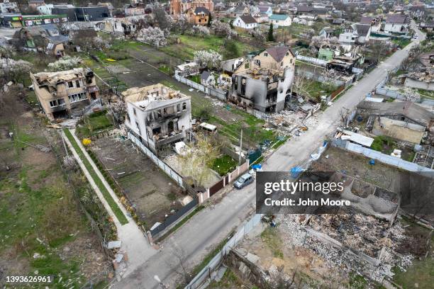 As seen from the air, wrecked homes stand near the former frontline between Russian and Ukrainian troops on April 25, 2022 in Hostomel, Ukraine. As...