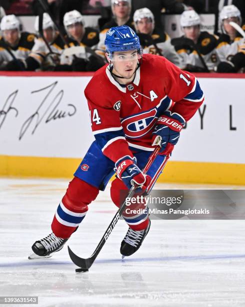Nick Suzuki of the Montreal Canadiens skates the puck against the Boston Bruins during the second period at Centre Bell on April 24, 2022 in...