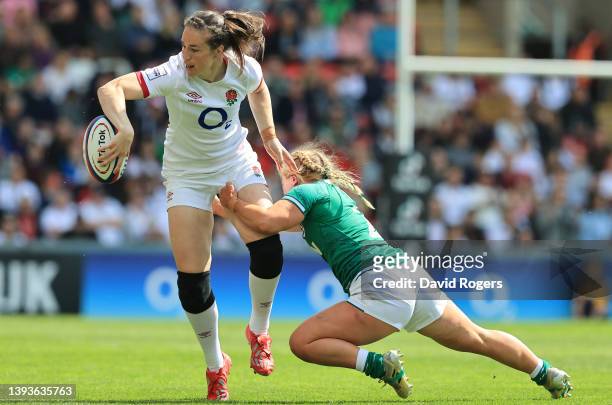 Emily Scarrett of England off loads the ball as Neve Jones tacles during the TikTok Women's Six Nations match between England and Ireland at Mattioli...