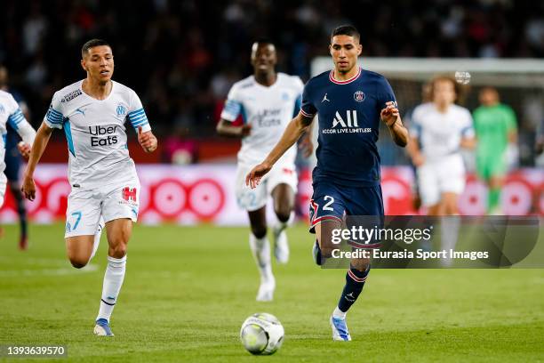 Achraf Hakimi of Paris Saint Germain is chased by Amine Harit of Marseille during the Ligue 1 Uber Eats match between Paris Saint-Germain and...