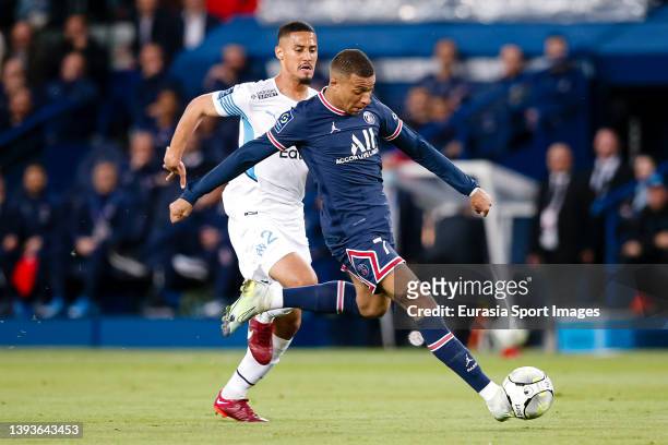 Kylian Mbappe of Paris Saint Germain is chased by William Saliba of Marseille during the Ligue 1 Uber Eats match between Paris Saint-Germain and...