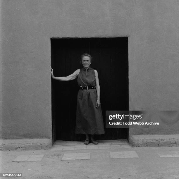 Portrait of American artist Georgia O'Keeffe as she poses in the Salita Door at her home, Abiquiu, New Mexico, 1956.