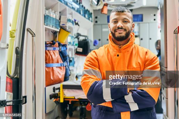 portrait man paramedic in front of ambulance. - emergency services occupation stockfoto's en -beelden