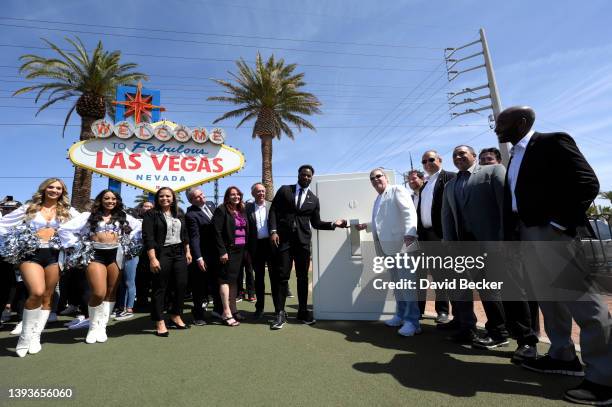 Former Las Vegas Raiders player Marcel Reese and Las Vegas Raiders owner Mark Davis flip an oversized ceremonial light switch during a kick-off event...