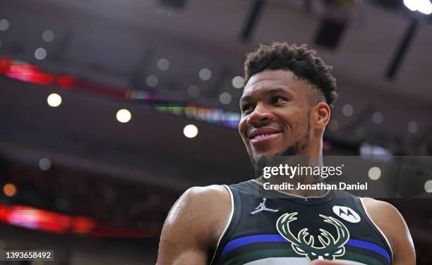 Giannis Antetokounmpo of the Milwaukee Bucks smiles at fans near the end of Game Four of the Eastern Conference First Round Playoffs against the...