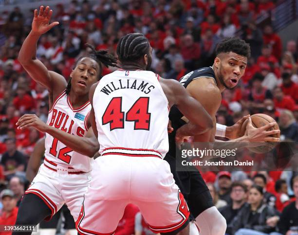 Giannis Antetokounmpo of the Milwaukee Bucks looks to move against Ayo Dosunmu and Patrick Williams of the Chicago Bulls during Game Four of the...
