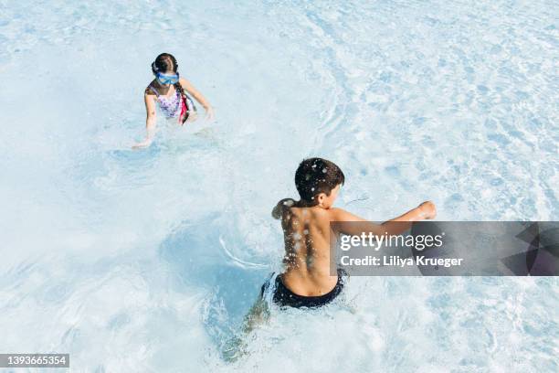 children have summer fun in the pool. - holiday hours stock-fotos und bilder