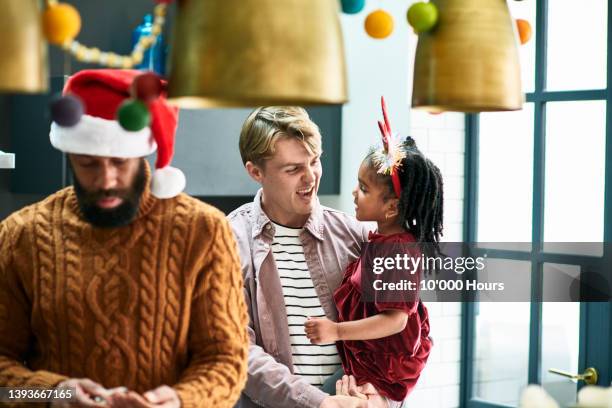 young white man laughing with black niece at family christmas party - uncle stock pictures, royalty-free photos & images