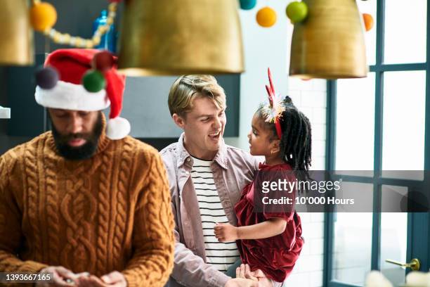 young white man laughing with black niece at family christmas party - niece 個照片及圖片檔