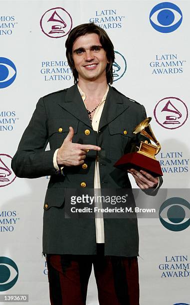 Singer Juanes poses with his Best Rock Song Award backstage during the 3rd Annual Latin Grammy Awards at the Kodak Theatre on September 18, 2002 in...