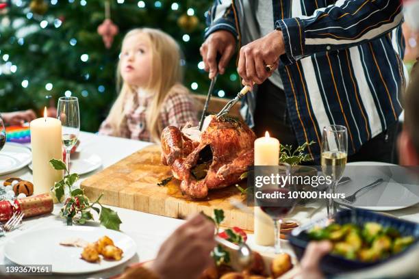 man carving christmas turkey on table - cooked turkey white plate imagens e fotografias de stock