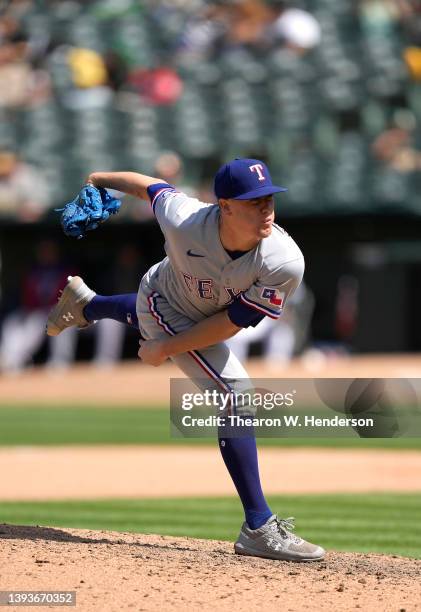 Kolby Allard of the Texas Rangers pitches against the Oakland Athletics in the bottom of the seventh inning at RingCentral Coliseum on April 24, 2022...
