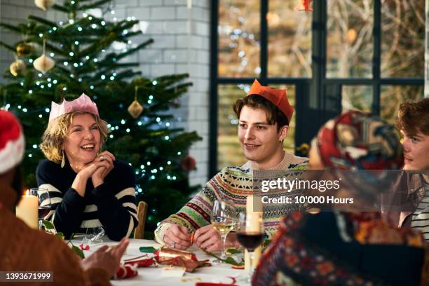 family playing after dinner game at christmas - christmas jumper stock pictures, royalty-free photos & images