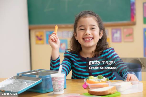 little girl eating healthy at school - kid school lunch stock pictures, royalty-free photos & images