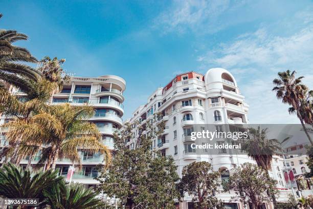 luxury apartment white buildings against blue sky on french riviera, luxury property in cannes, provence, france - cannes building stock pictures, royalty-free photos & images