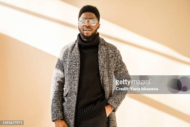 stylish african american man in glasses posing at camera - fashion show model stock pictures, royalty-free photos & images