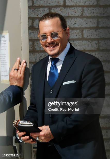 Johnny Depp steps outside court during his civil trial at Fairfax County Circuit Court on April 25, 2022 in Fairfax, Virginia. Depp is seeking $50...