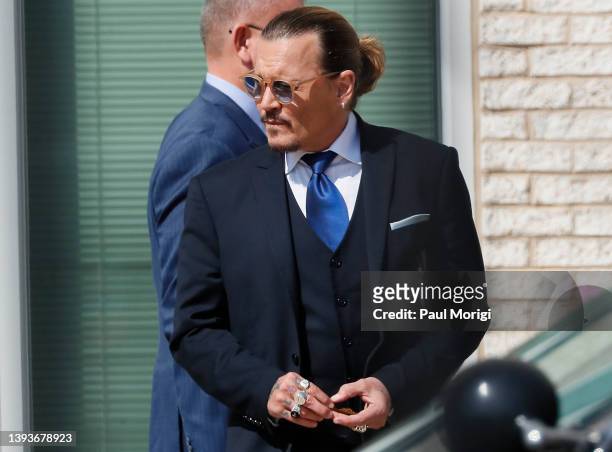 Johnny Depp steps outside court during his civil trial at Fairfax County Circuit Court on April 25, 2022 in Fairfax, Virginia. Depp is seeking $50...