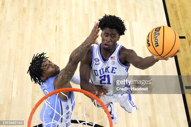 Griffin of the Duke Blue Devils drives to the basket against Caleb Love of the North Carolina Tar Heels during the first half in the semifinal game...