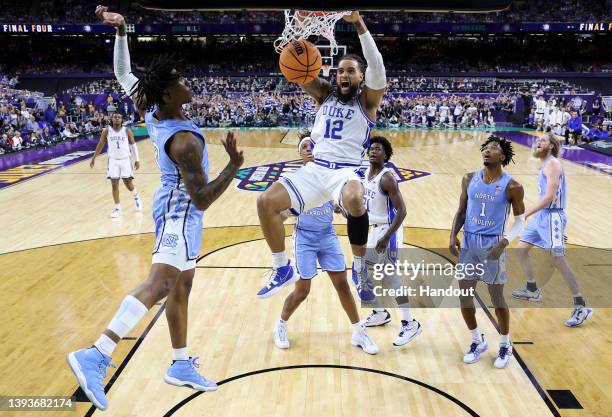 Theo John of the Duke Blue Devils dunks the ball against the North Carolina Tar Heels during the first half in the semifinal game of the 2022 NCAA...