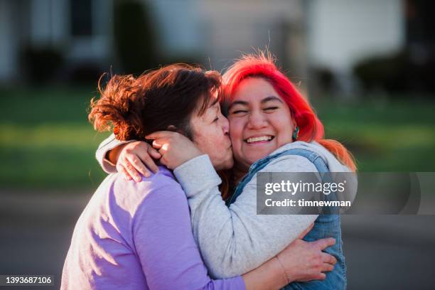 golden hour hugs from mother to daughter - family hugging bright stock pictures, royalty-free photos & images