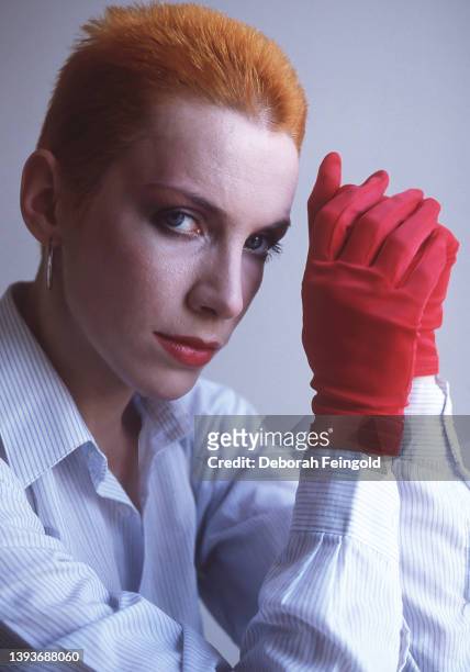 Deborah Feingold/Corbis via Getty Images) Portrait of Scottish New Wave and Pop singer Annie Lennox, of the group Eurythmics, as she poses in a white...