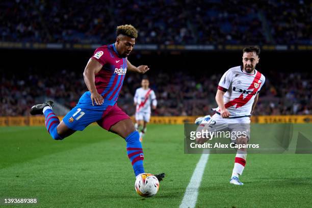 Adama Traore of FC Barcelona plays the ball whilst under pressure from Unai Lopez of Rayo Vallecano during the LaLiga Santander match between FC...