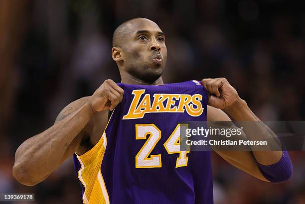 Kobe Bryant of the Los Angeles Lakers adjusts his jersey during the NBA game against the Phoenix Suns at US Airways Center on February 19, 2012 in...